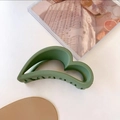 Detail view of large matte grass green hair claw clip with non-slip teeth and cloud shape - Green