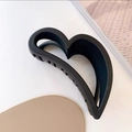 Detailed view of a matte black heart-shaped hair claw clip with a hollowed-out design - Black
