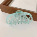 Macro detail of mint green translucent hair claw clip with multi-tooth octopus design - Lake Green
