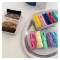 Detailed set of colorful elastic hair ties in a clear five-compartment organizer box - Multicolor