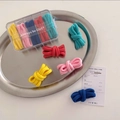 Detail of colorful elastic hair bands set in a clear organizer box on a metal tray - Candy Colors