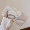 Detailed close-up of a soft cream fabric headband with elegant twisted knot design - Solid Twist Style / Off-white