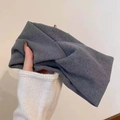 Detailed texture of dark grey knitted wide headband featuring a stylish cross-knot design - Solid Twist Style / Gray
