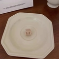 Close-up of a matte peach mini hair claw clip on a white plate with aesthetic background - Light Pink