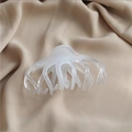 Large creamy white octopus-shaped hair claw clip on soft beige fabric background - Ice White