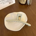 Matte bean green shark hair claw clip displayed on a minimalist ceramic tray detail - Matte Apricot