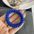 Detailweergave van een flexibele spiraalvormige haarband in diepblauw glanzende afwerking - Glanzend Blauw