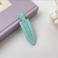 Pastel light blue hair clips with matte finish shown on a book for hair styling - Lake Green