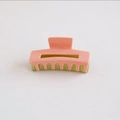 Detail view of pink and avocado green checkered acetate hair claw clip for elegant styling - Pink Green Contrast