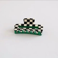 Detail of checkered acetate hair claw clip featuring green teeth and spring mechanism - Black Checkerboard and Dark Green