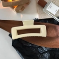 Macro detail of a 12.5cm cream matte rectangular hair claw clip on a luxury display - Large Square Cream Claw Clip approx 12.5cm