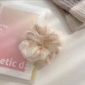 Detail shot of oversized mesh scrunchie with pink floral prints on off-white fabric - Large / Beige