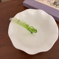 Détail de la pince à cheveux translucide vert émeraude avec design ajouré dans un bol - Vert Dégradé