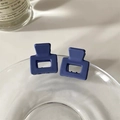 Detail of square matte Morandi blue-purple hair claws clipped on a glass tray edge - Navy Blue