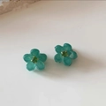 Close-up of small teal flower hair claws with crystal center for women hair styling - Rhinestone Green
