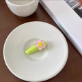 Close-up of a cute green floral hair clip with a pink flower on a white ceramic plate - Apple Green-Flower
