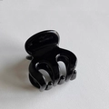 Close-up of a glossy black octopus hair claw clip for high ponytail stability - Solid Black