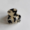 Detailed shot of a mini hair claw clip featuring a marble-patterned resin texture - Cream Tortoise
