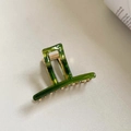 Close-up of green marble pattern acrylic hair claw clip with golden metal spring and teeth - Glass Green