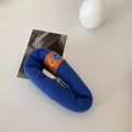 Detailed view of plush blue sponge hair clip with orange smiley face patch and metal BB clip - Sapphire Blue