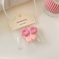 Detail of two pink flower hair clips in transparent packaging with card header - Pink Clip