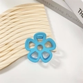 Detail of blue hollow five-petal flower hair claw clip with a matte frosted finish - Blue