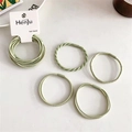Detailed macro view of green braided elastic hair ties in double-strand spiral design - Matcha Green