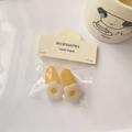 Detail of cream yellow flower hair clips with white resin petals on a display card - Jelly Yellow