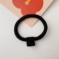 Close-up of thick black braided hair tie with a textured matte square decorative buckle - Twisted Chain / Black