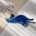 Detailed macro view of dark blue starry acetate cat hair clip with golden outlines - Starry Ocean Blue