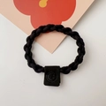 Detail of black braided high-elastic hair tie with a square smiley face charm - Chain Style / Black