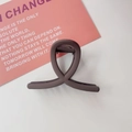Detailed view of dark brown matte hair claw clip with interlocking loop design on white background - Matte Coffee