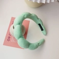 Detail of mint green braided padded headband with soft fabric texture and hand made label - Green