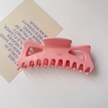 Close-up of a large pink acetate hair claw clip with Barrette La France engraving - Pink