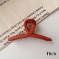 Detail view of a 11cm matte orange hair claw clip on minimalist white background - M / Matte Orange