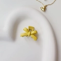 Close-up of a matte yellow bow hair claw clip displayed on a white heart-shaped plate - Painted Yellow (Metal)