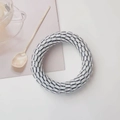 Detailed view of white and black striped spiral hair tie on a minimalist background - White Striped
