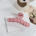 Detail of pink daisy hair claw clip with matte finish on a minimalist white table background - Matte Pink