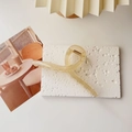 Detailed top view of a cream yellow acrylic hair claw clip on a textured stone surface - L / Transparent Yellow
