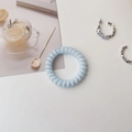 Detail of light blue spiral hair tie and silver earrings on minimalist white background - Forest Sky Blue