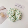 Detail of floral scrunchie hair tie with green flower pattern on white cotton fabric - White Green Flower