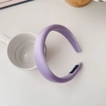 Detail view of purple satin sponge headband with Hand Made label on a white cup - Light Purple