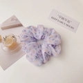 Detail of lavender floral scrunchie in semi-transparent fabric for ponytail styling - Light Purple Flower
