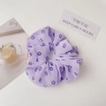 Detailed view of light purple floral scrunchie with soft fabric texture on white background - Purple Flower
