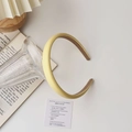 Detail of light yellow leather headband with brown non-slip lining and thick foam design - Leather / Yellow