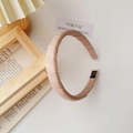 Detailed macro view of beige pleated fabric headband featuring a black handmade textile label - Fabric Headband / Khaki