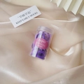 Detail of purple high-elastic hair bands in a transparent bottle on silk fabric - Jar Purple