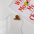 Detail of a brown acetate hair claw featuring a golden France Handmade inscription - Milk Coffee