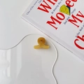 Detail view of mini amber acetate hair claw clip with France Handmade lettering - Yellow