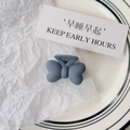 Detail of matte gray-blue butterfly hair clip on elegant white paper and ceramic dish - Bowknot Style / Matte Fog Blue Butterfly